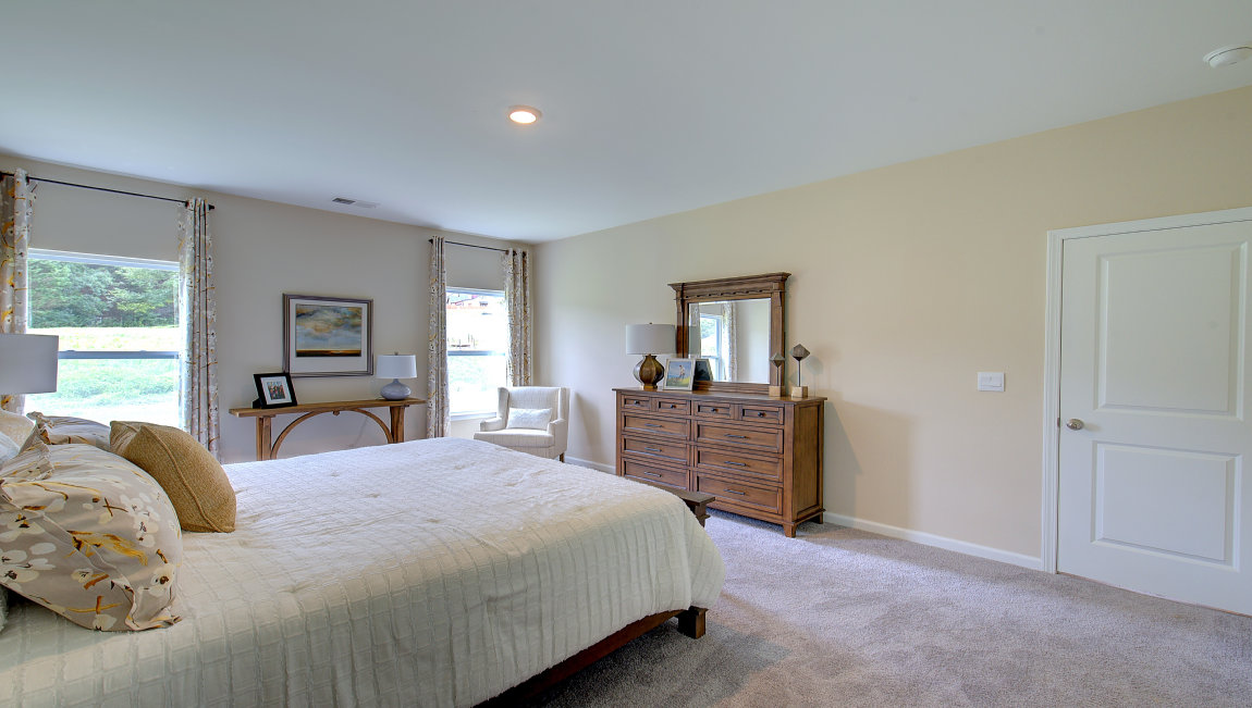 Carpeted bedroom with large windows