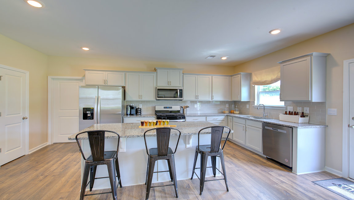 Open concept kitchen with large island and stainless steel appliances