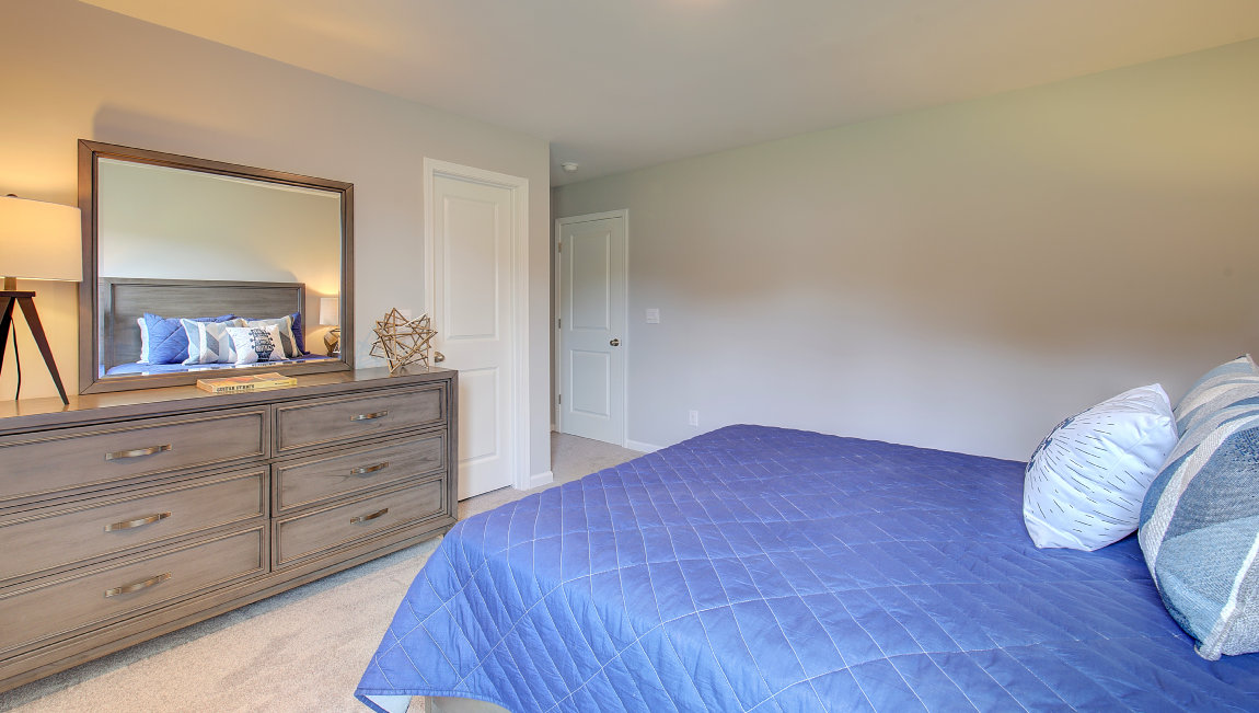 Carpeted bedroom with large window