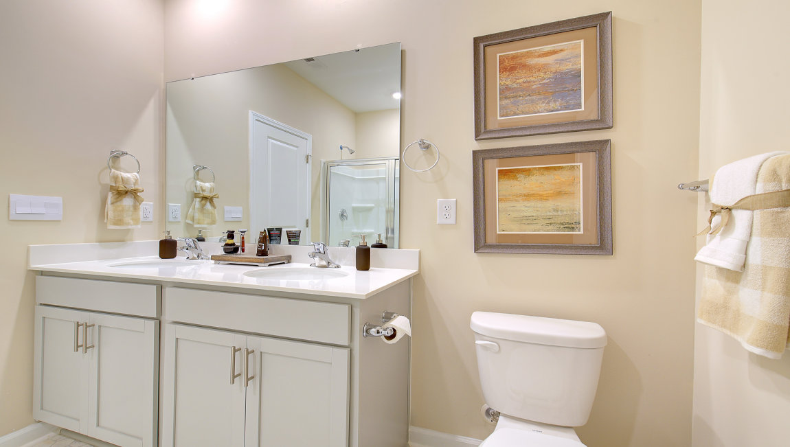 Primary bathroom with dual vanity and walk in shower