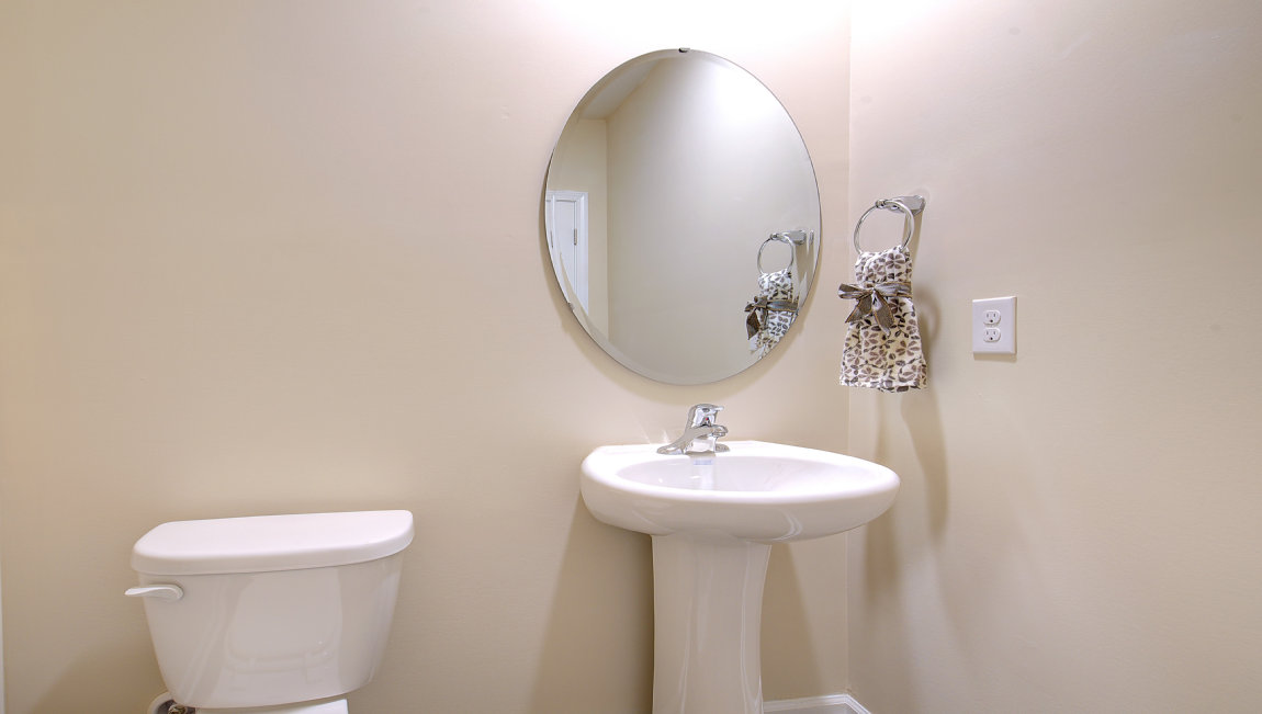 Half bathroom with single sink and mirror