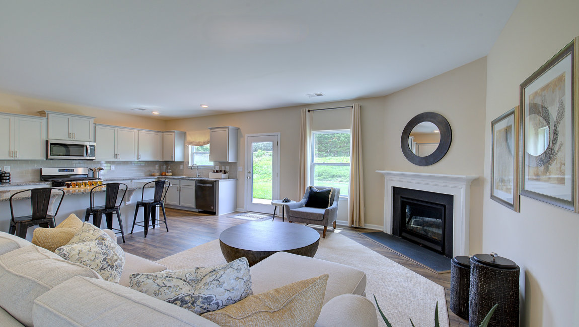 Open family room area with large windows and gas fireplace