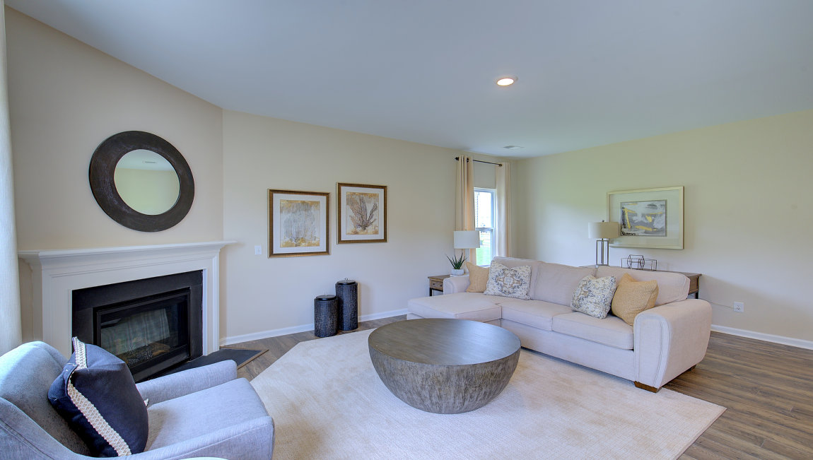 Open family room area with large windows and gas fireplace