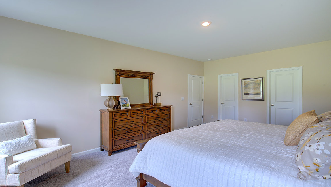 Capeted bedroom with large windows