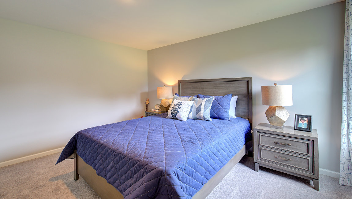 Capeted bedroom with large windows