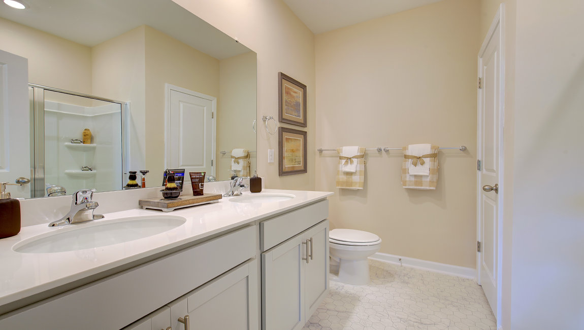 Primary bathroom with dual vanity and walk in shower