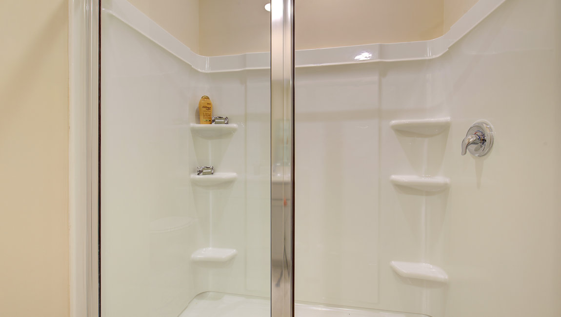 Primary bathroom with dual vanity and walk in shower