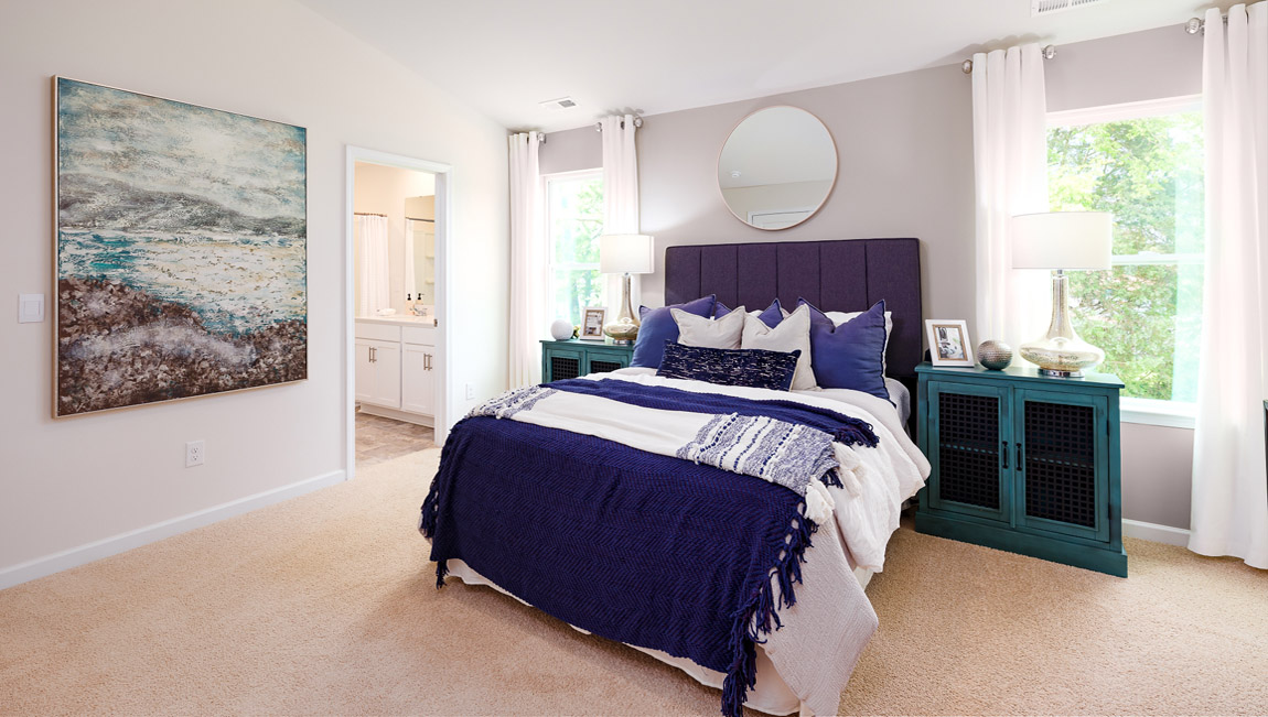 carpeted bedroom with two windows