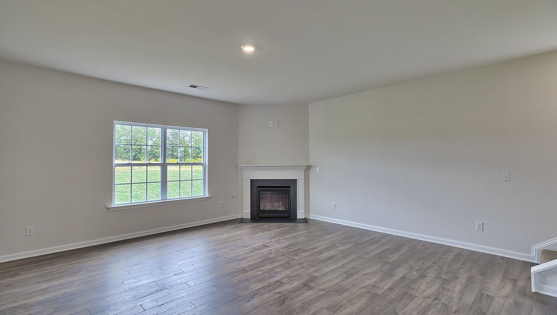 Living area with electric fireplace and large windows