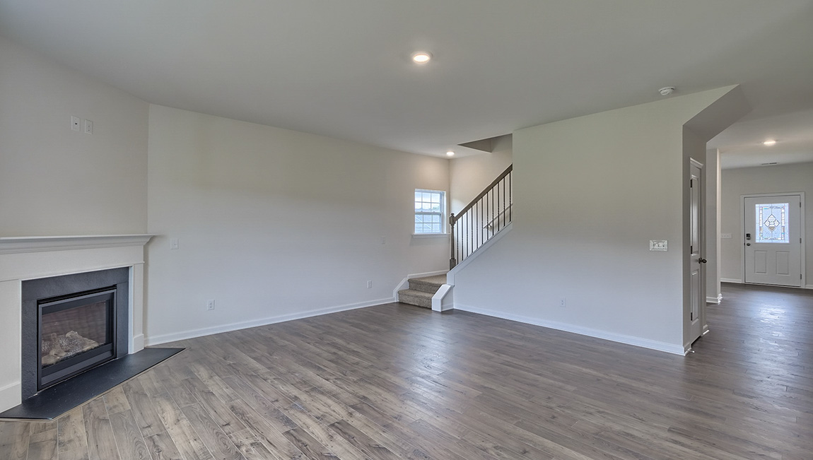 Living area with electric fireplace and large windows