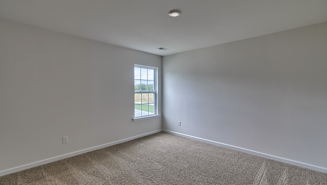 Carpeted bedroom with window