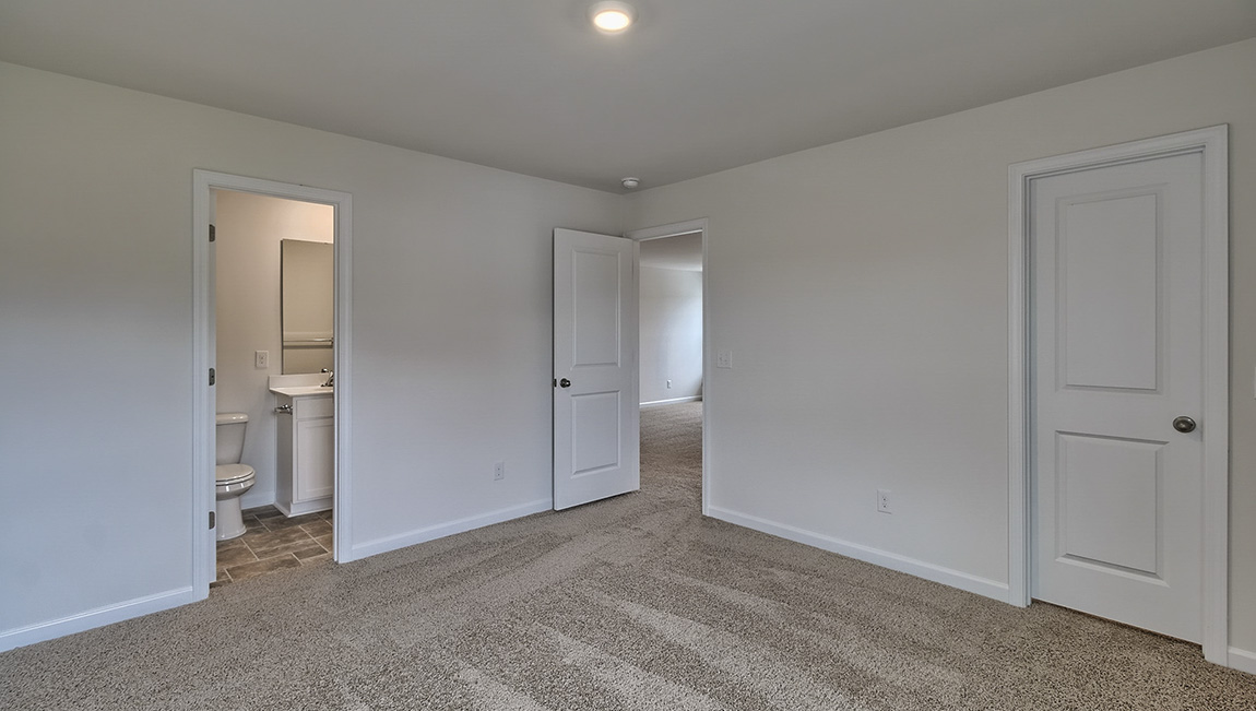 Carpeted bedroom with window