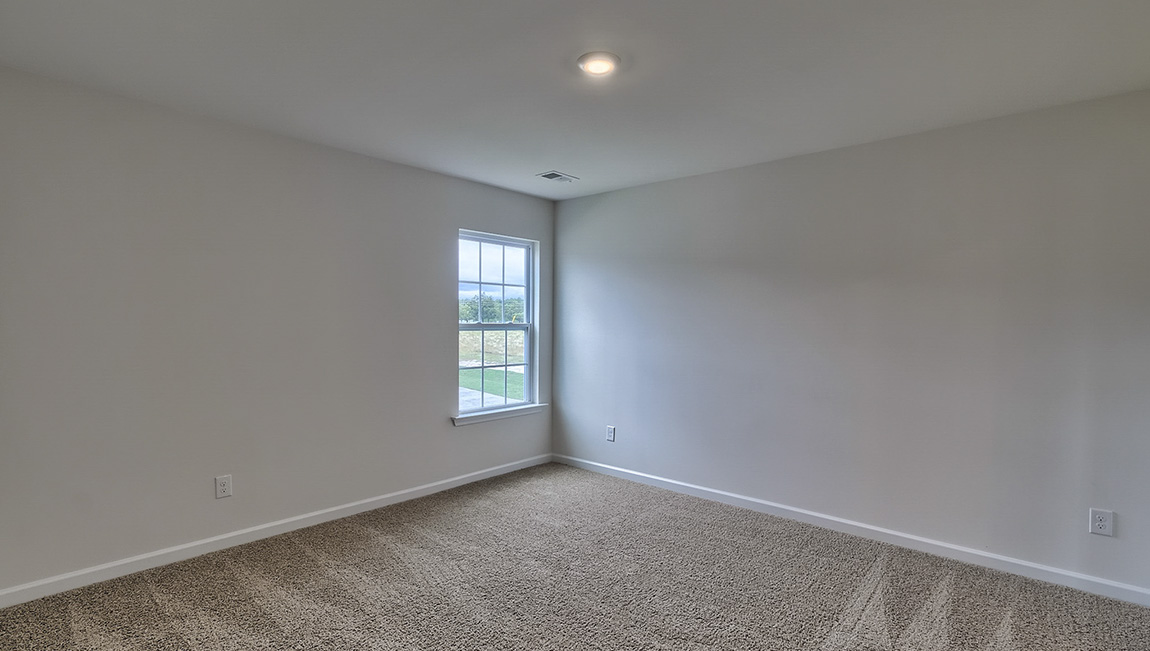 Carpeted bedroom with window