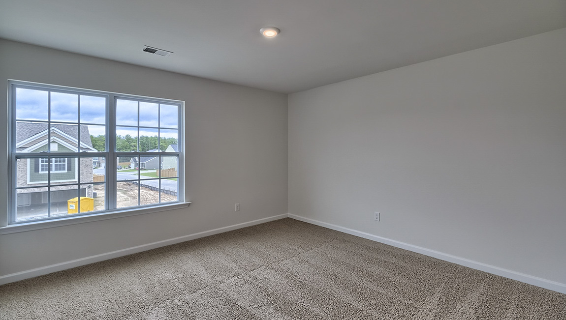Carpeted bedroom with window