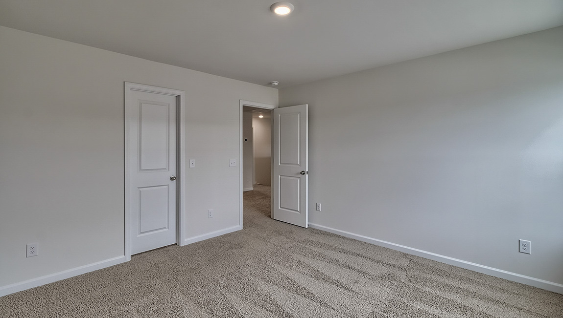 Carpeted bedroom with window