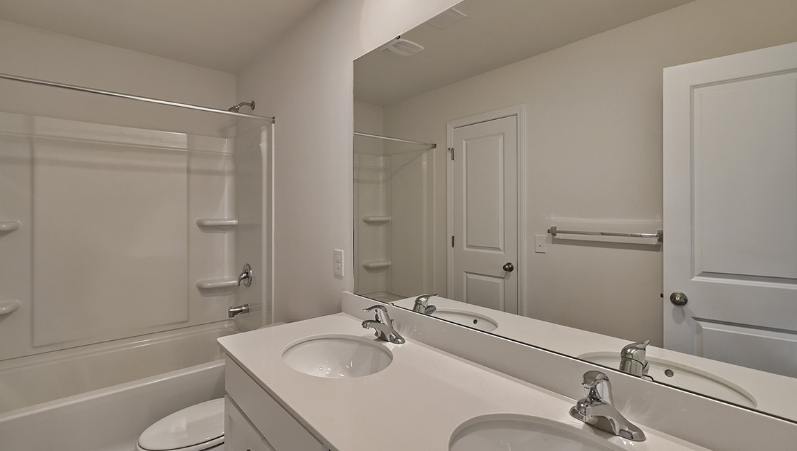 Bathroom with double vanity and tub
