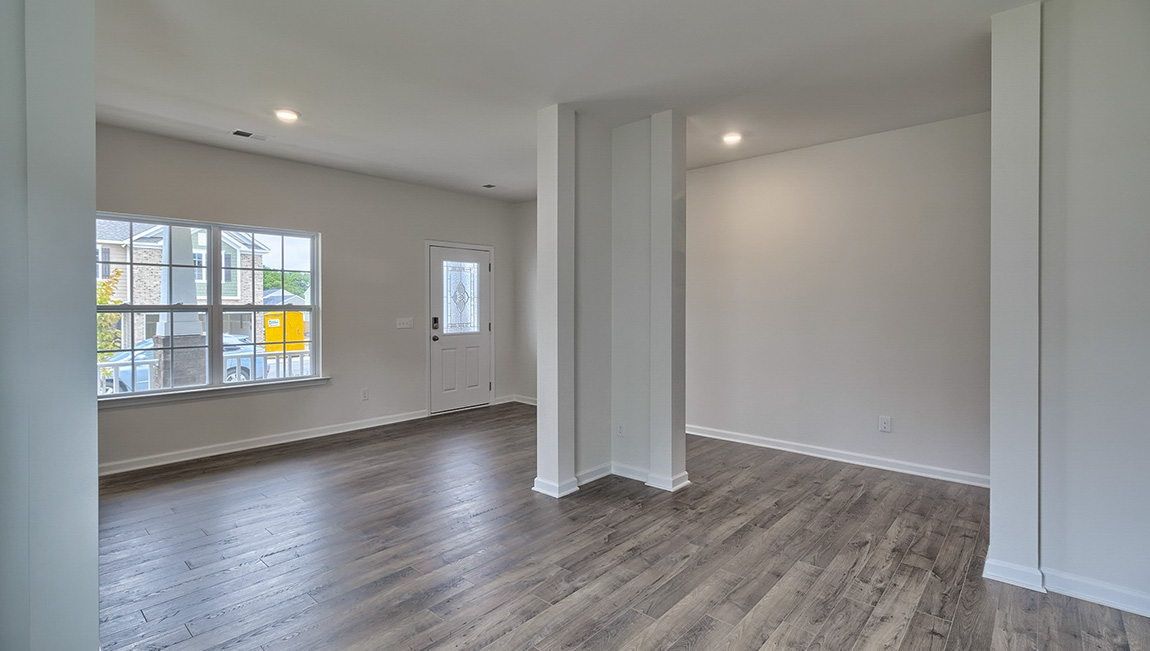 Open living/ dining space with windows