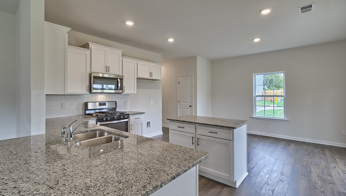 Open kitchen with island and stainless steel appliances