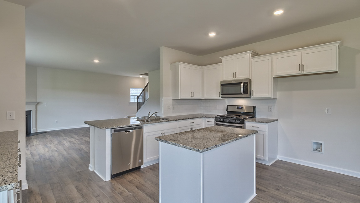 Open kitchen with island and stainless steel appliances