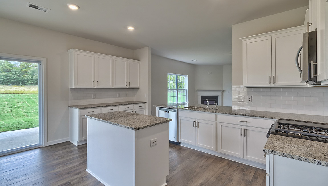 Open kitchen with island and stainless steel appliances