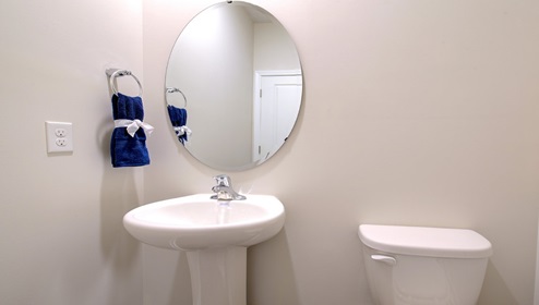 Powder bathroom with small sink and toilet