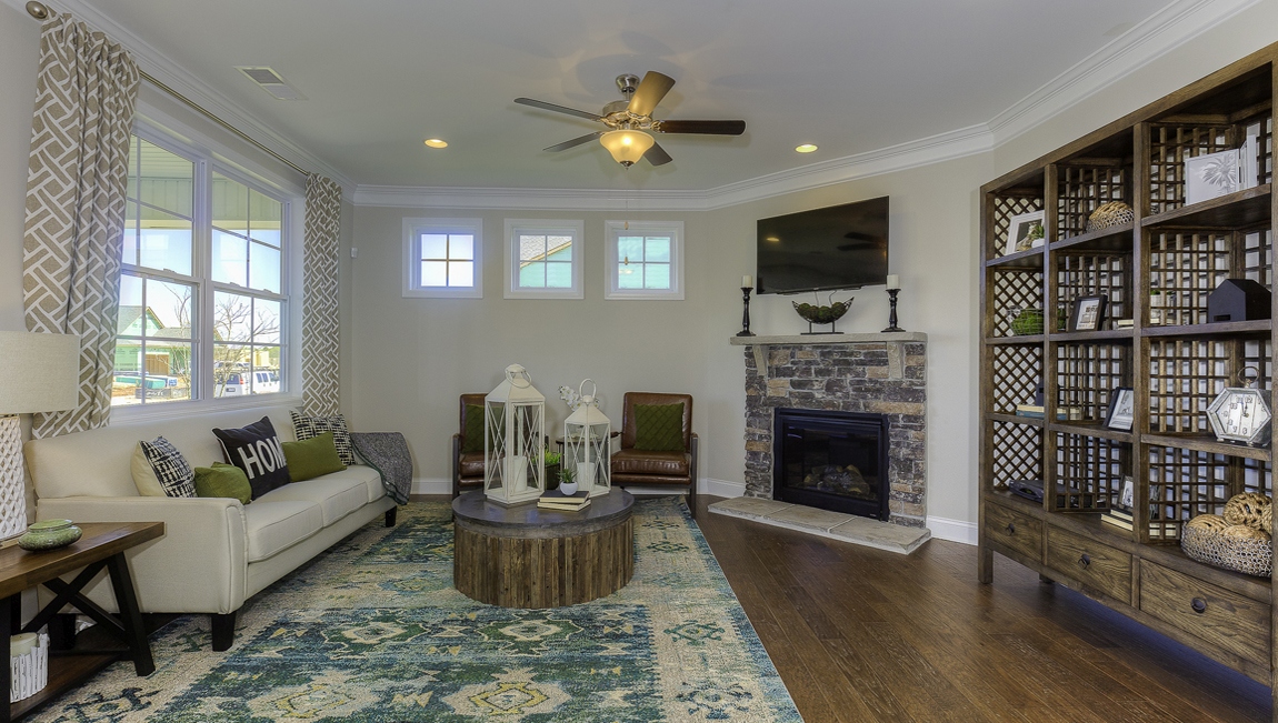 Living room space with large window and fireplace