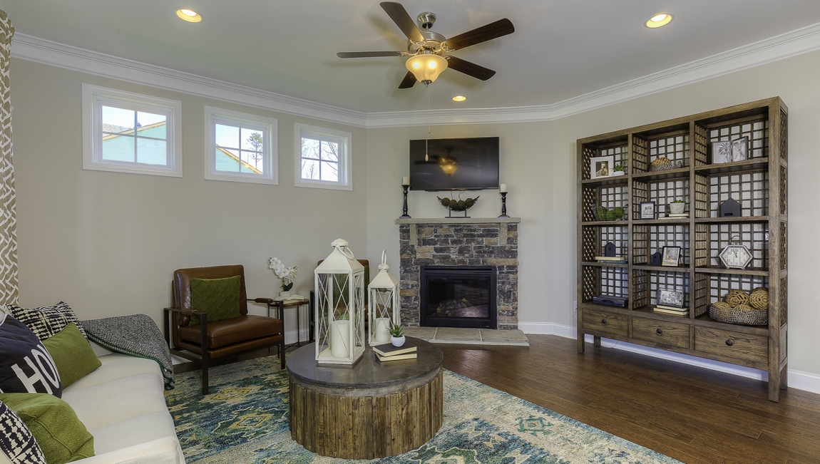 Living room space with large window and fireplace