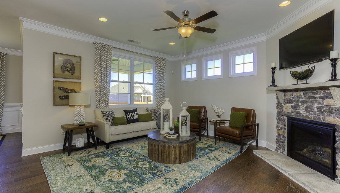 Living room space with large window and fireplace