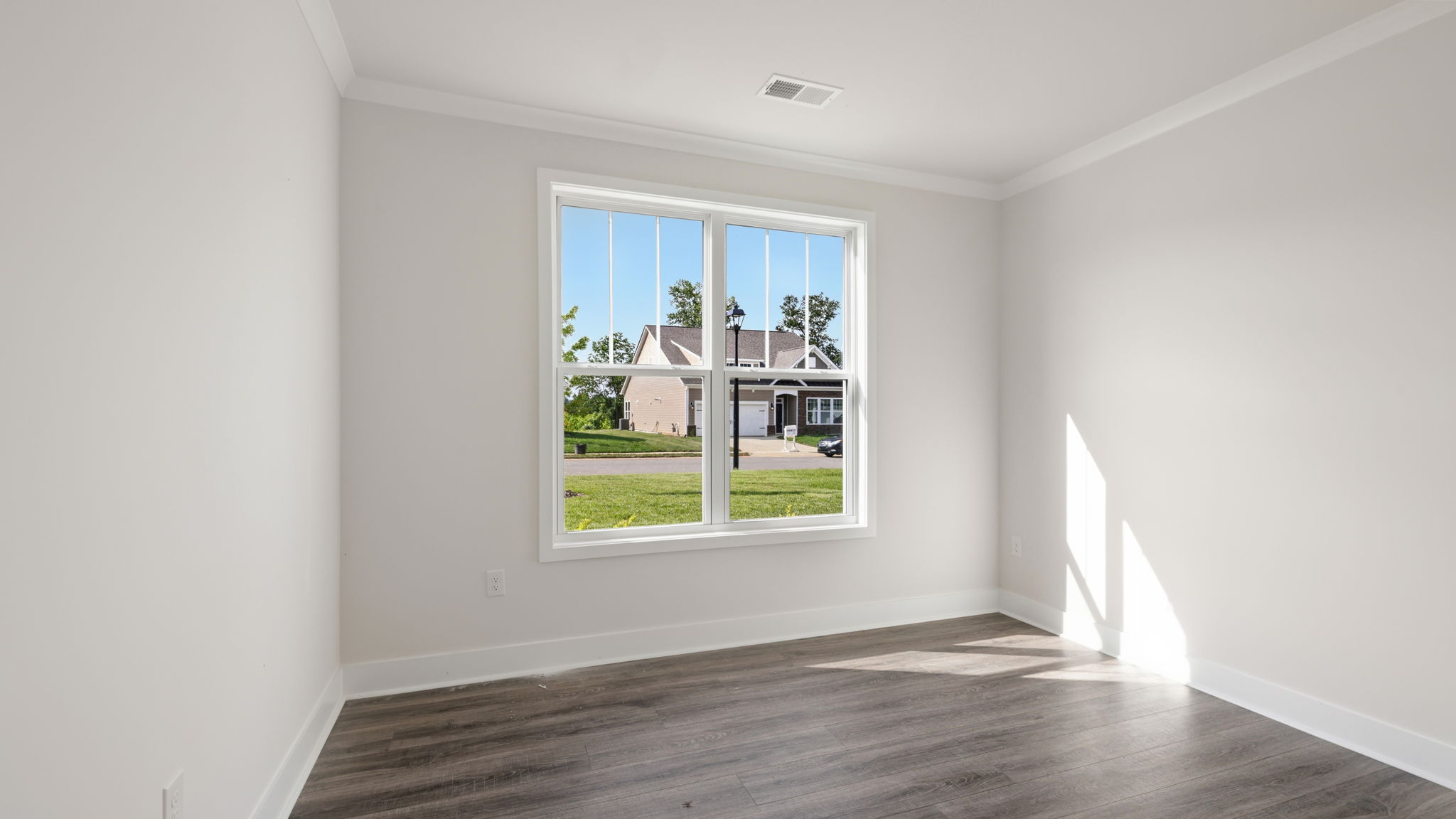 Bedroom with white walls and large window