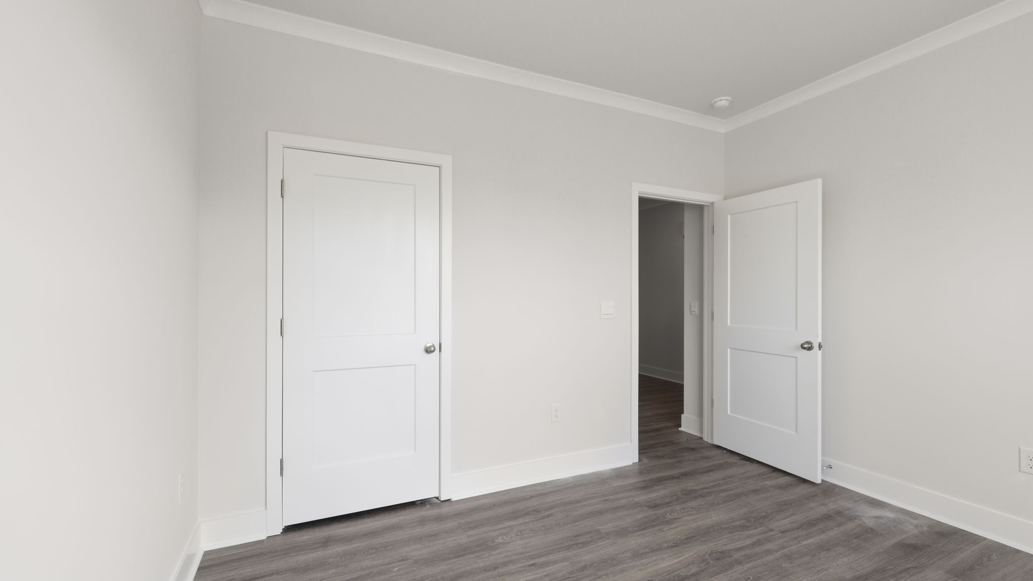 Bedroom with white walls and large window