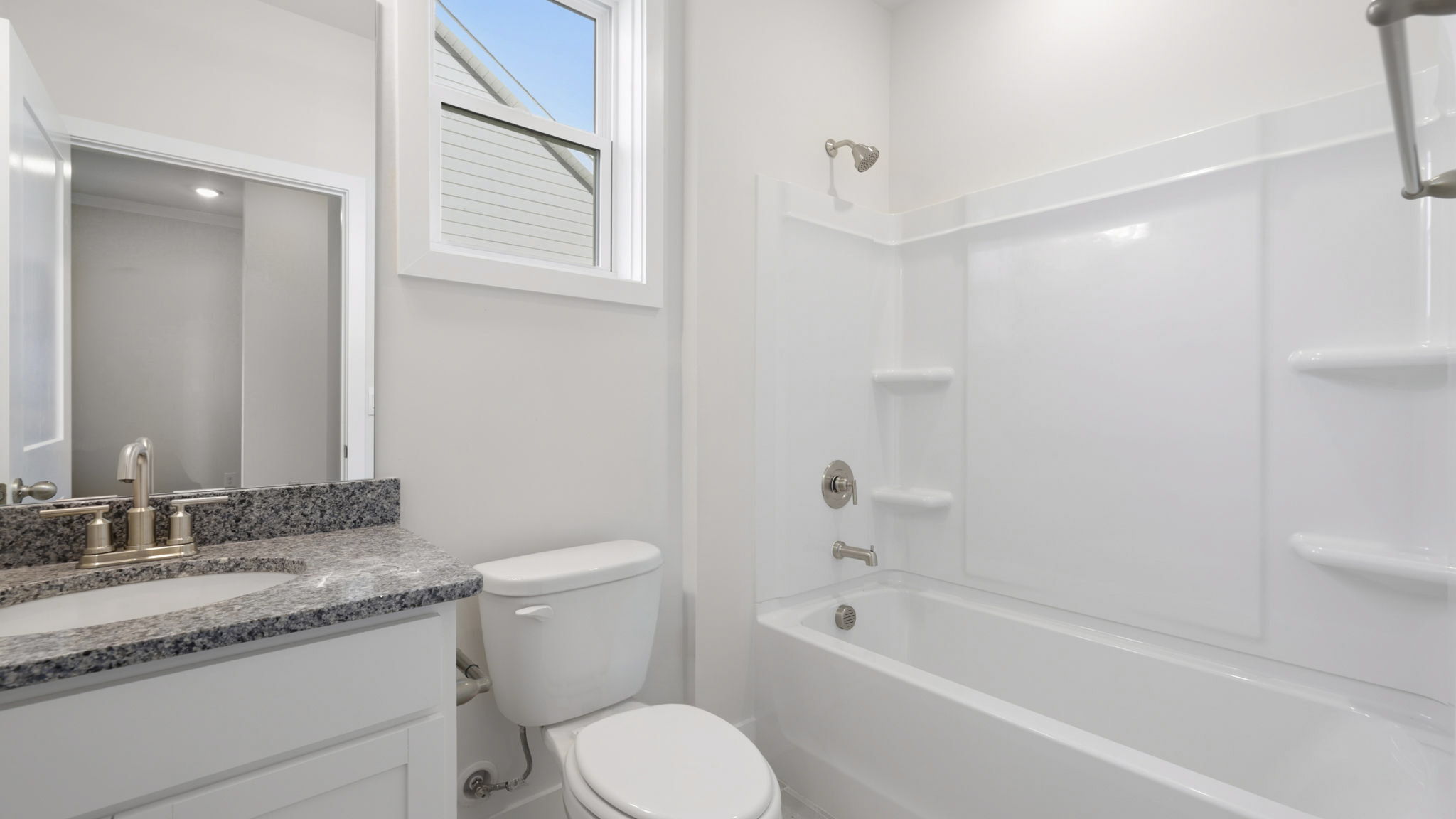 Bathroom with single vanity and bathtub