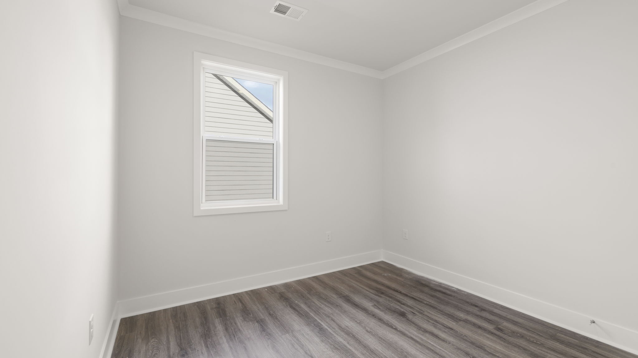 Bedroom with white walls and large window