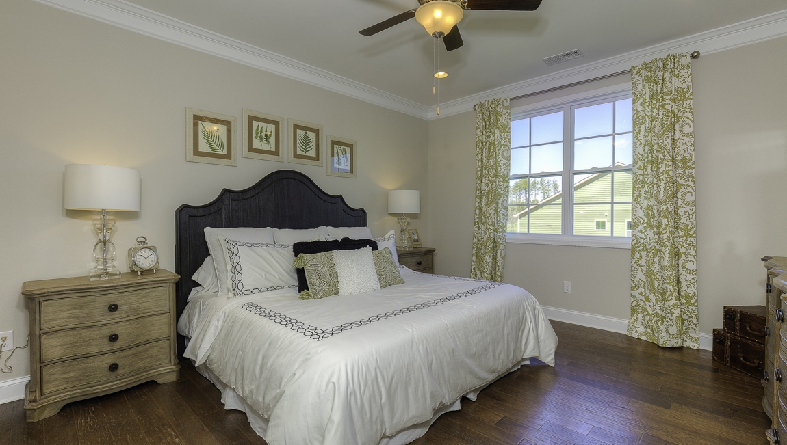 Primary bedroom, wood floors, large windows