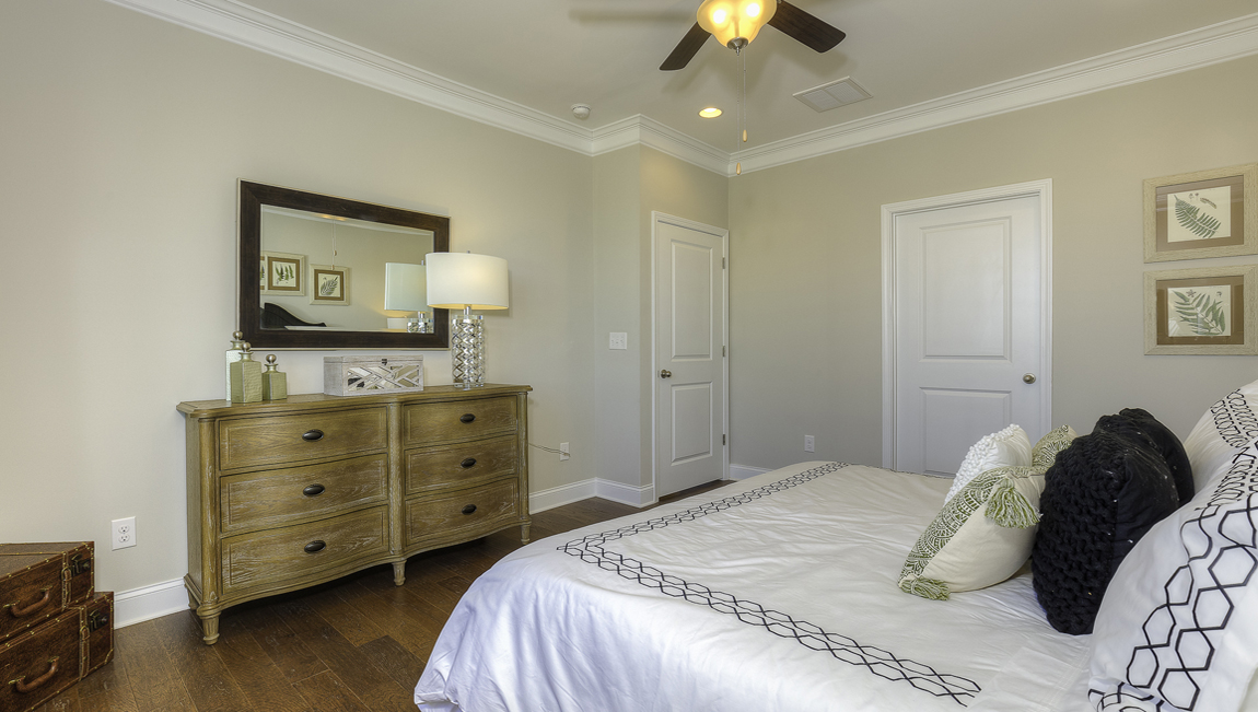 Primary bedroom, wood floors, large windows