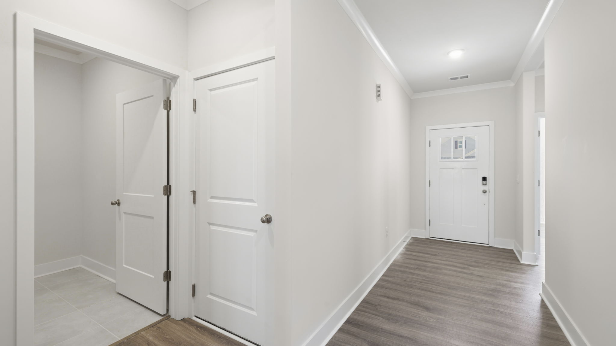 Hallway view with front foyer and interior view of front door