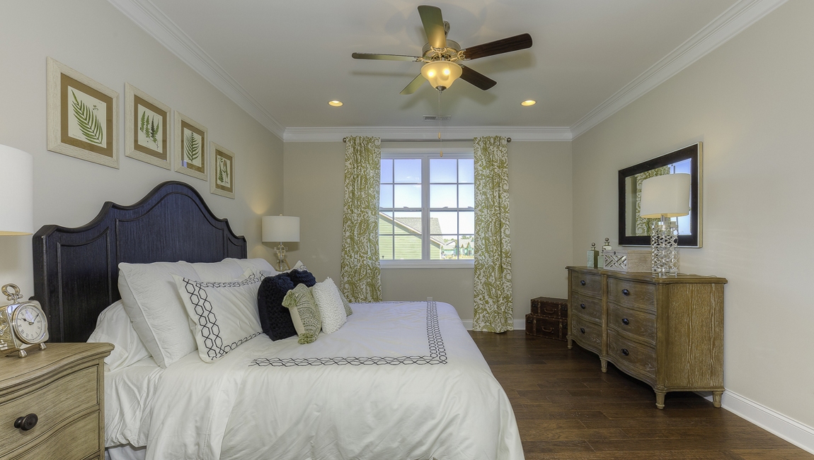 Primary bedroom, wood floors, large windows