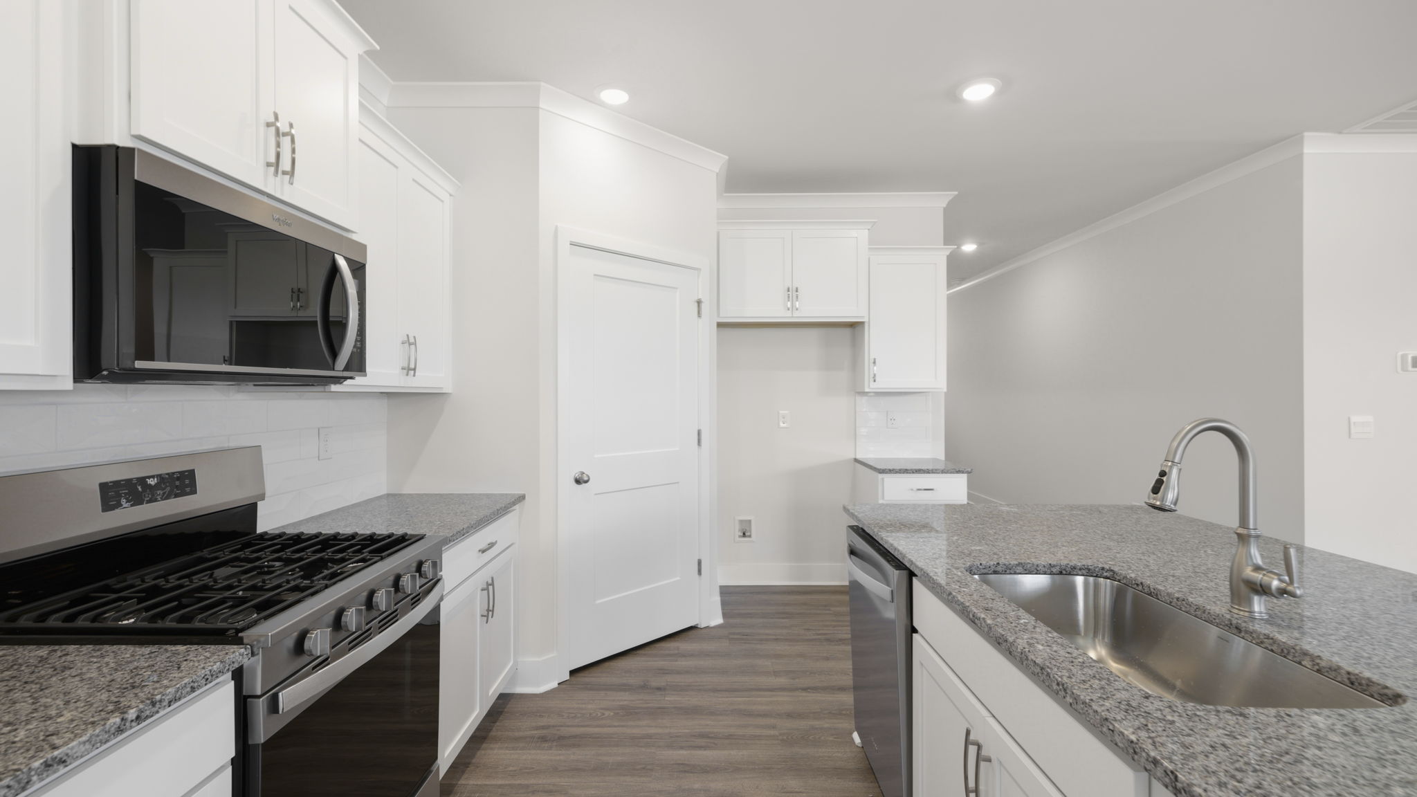 Modern, open concept kitchen with island and stainless-steel appliances