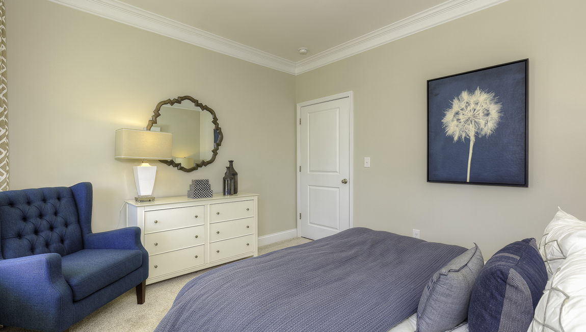 Carpeted bedroom with two windows