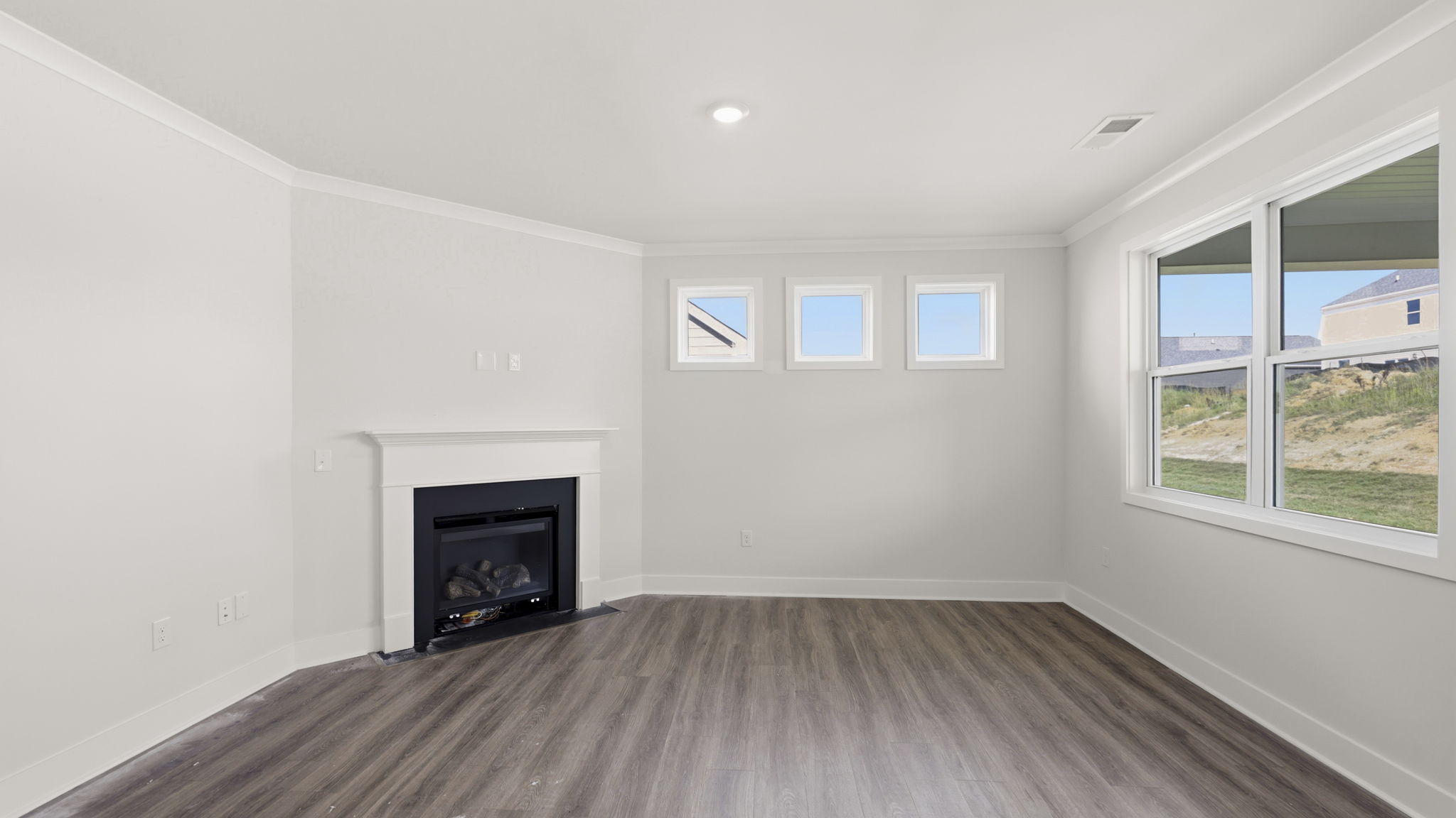 Open concept living area with gas fireplace and large windows