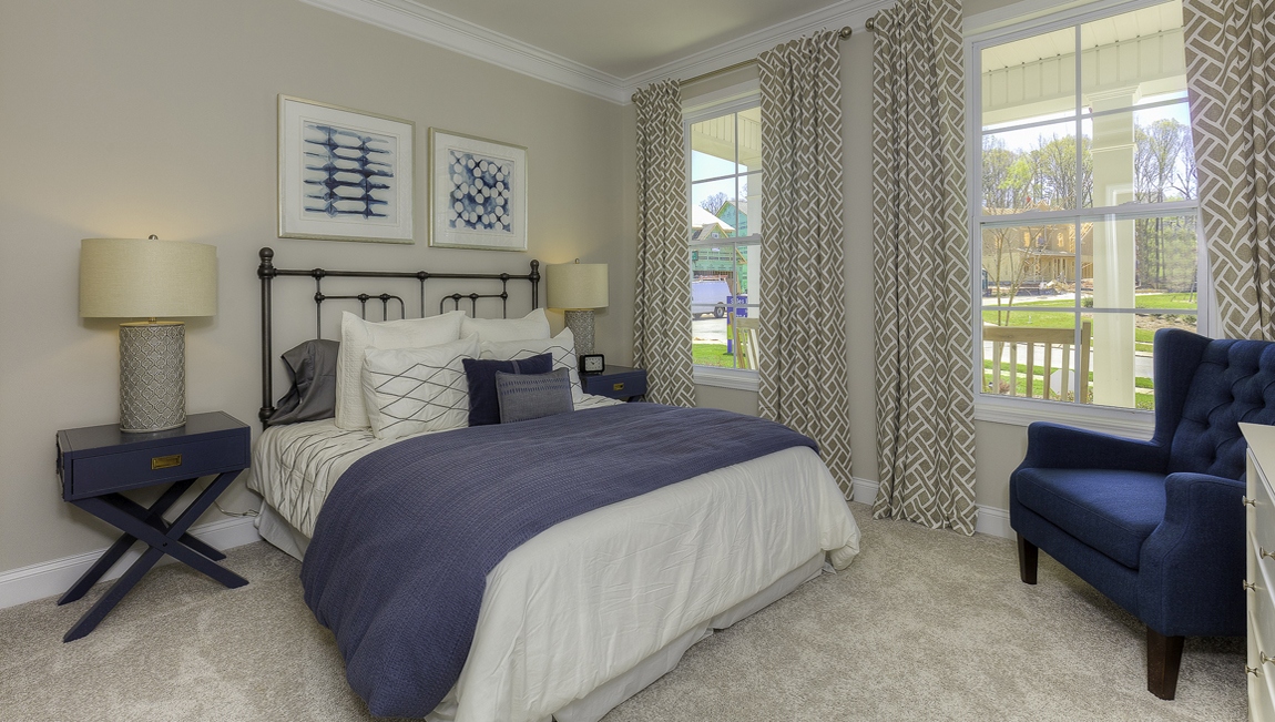 Carpeted bedroom with two windows
