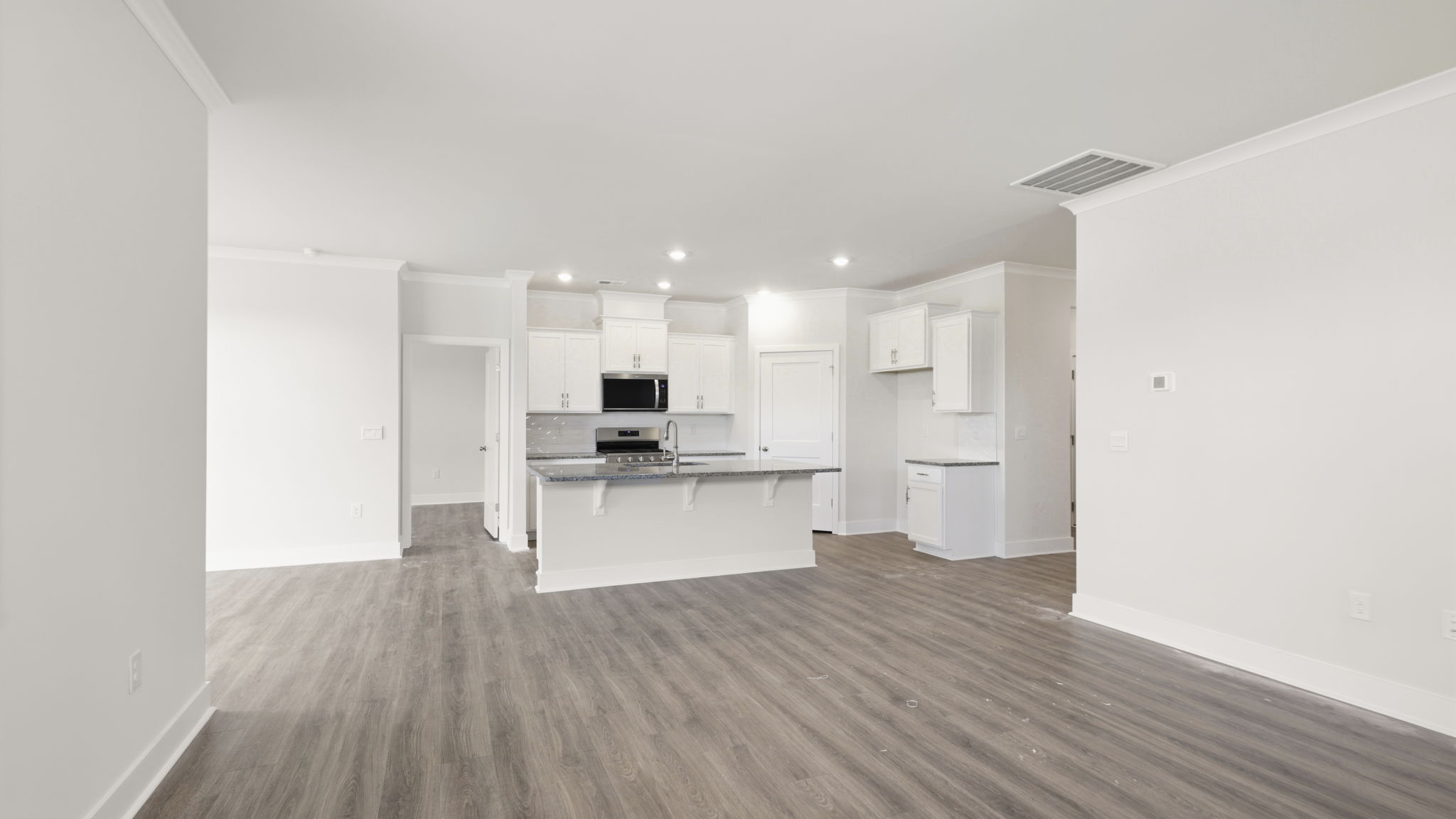 Modern, open concept living area with seamless blend into kitchen with large island