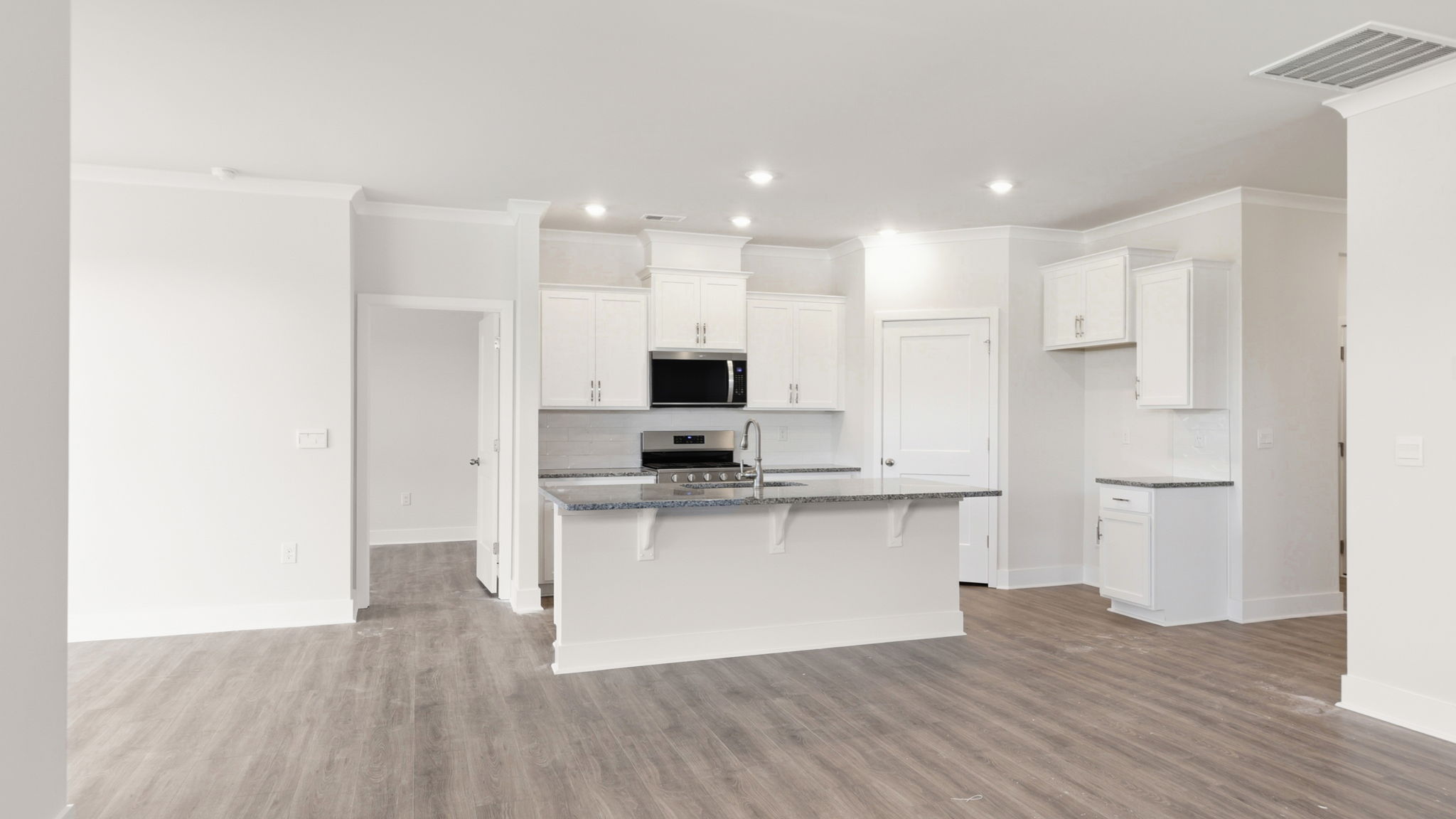 Modern, open concept living area with seamless blend into kitchen with large island