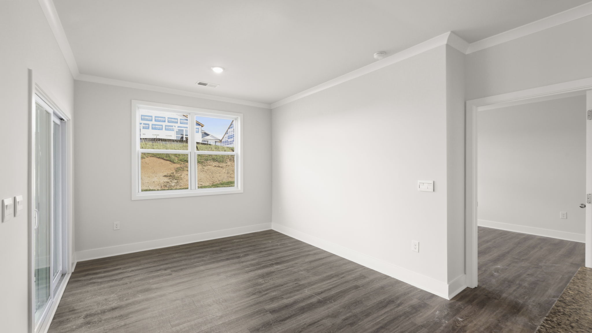 Open dining area with sliding glass doors and large window