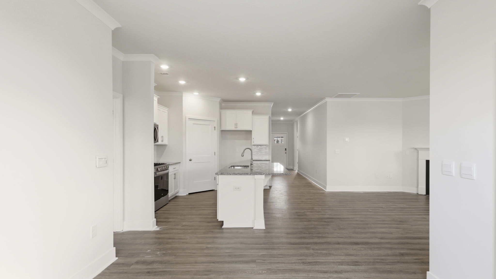 Modern, open concept living area with seamless blend into kitchen with large island