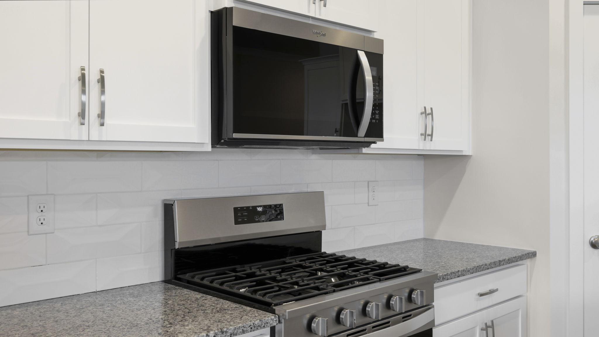Modern, open concept kitchen with island and stainless-steel appliances