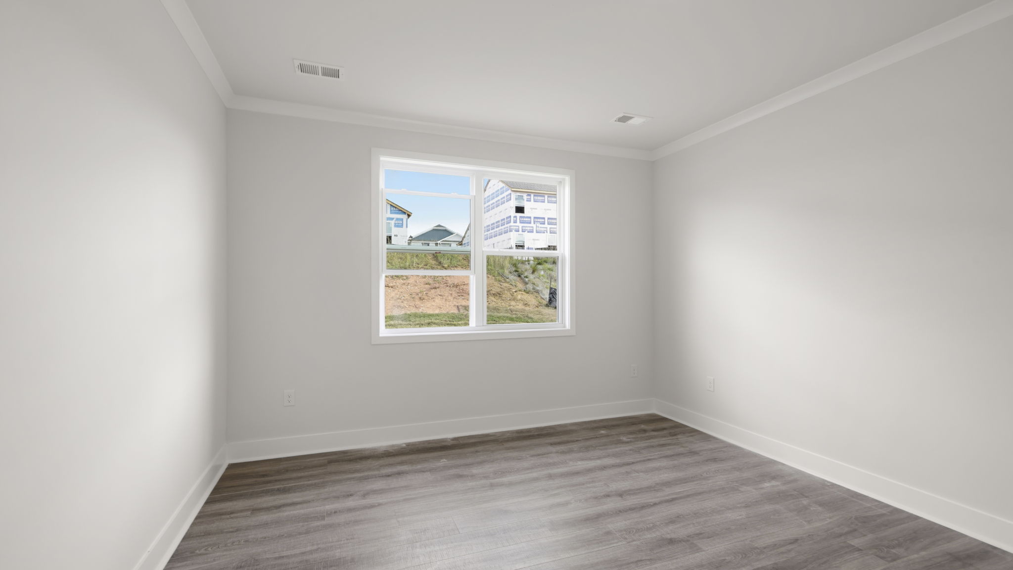 Large bedroom with white walls and large window