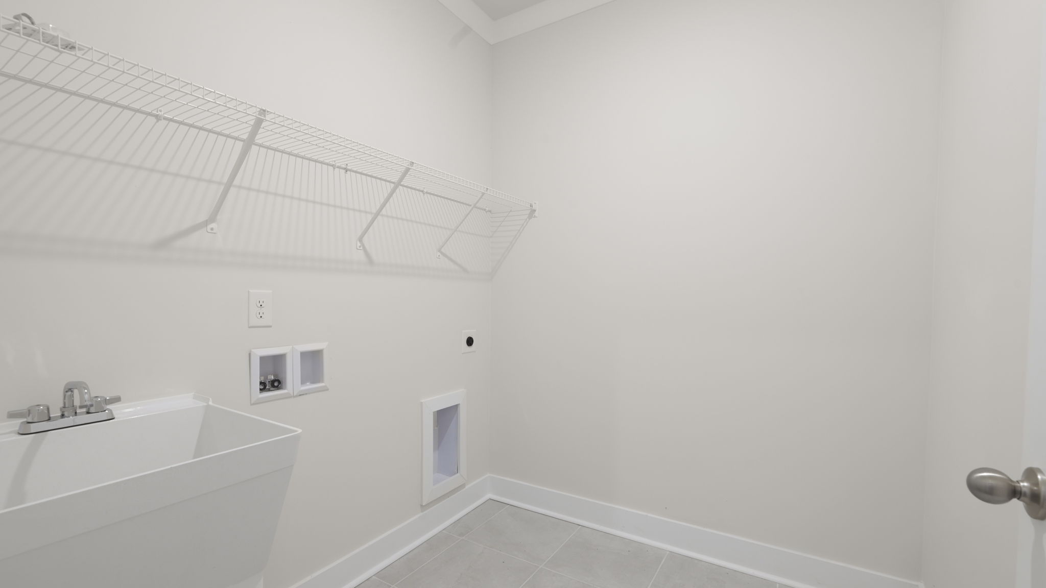 Laundry room with shelving and utility sink