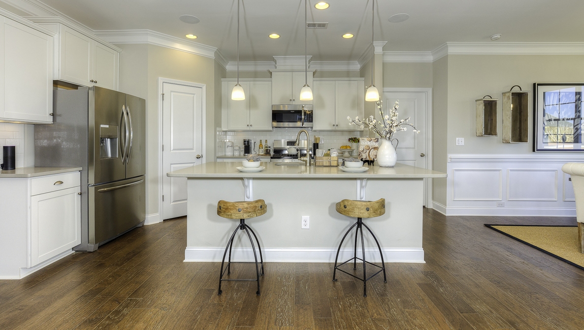 Kitchen and  island, white counters and cabinets, wood floors