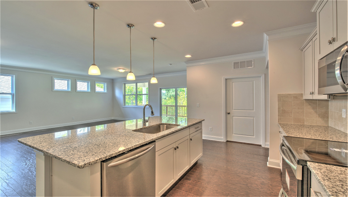 Open concept kitchen with island and stainless steel appliances
