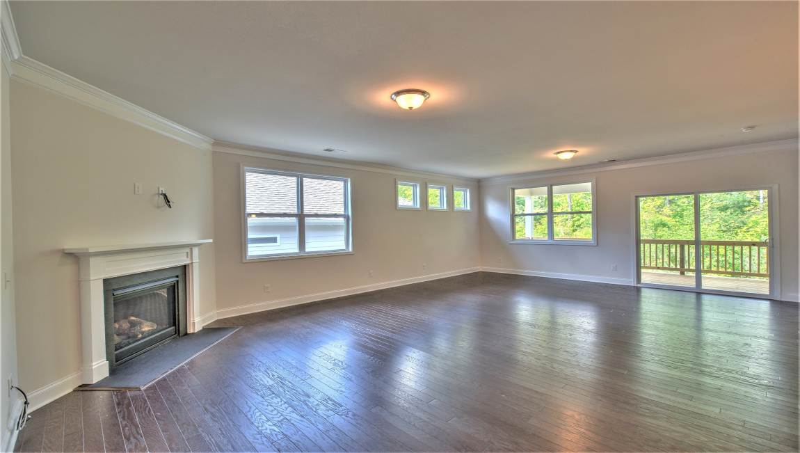 Open living area with large windows and fireplace